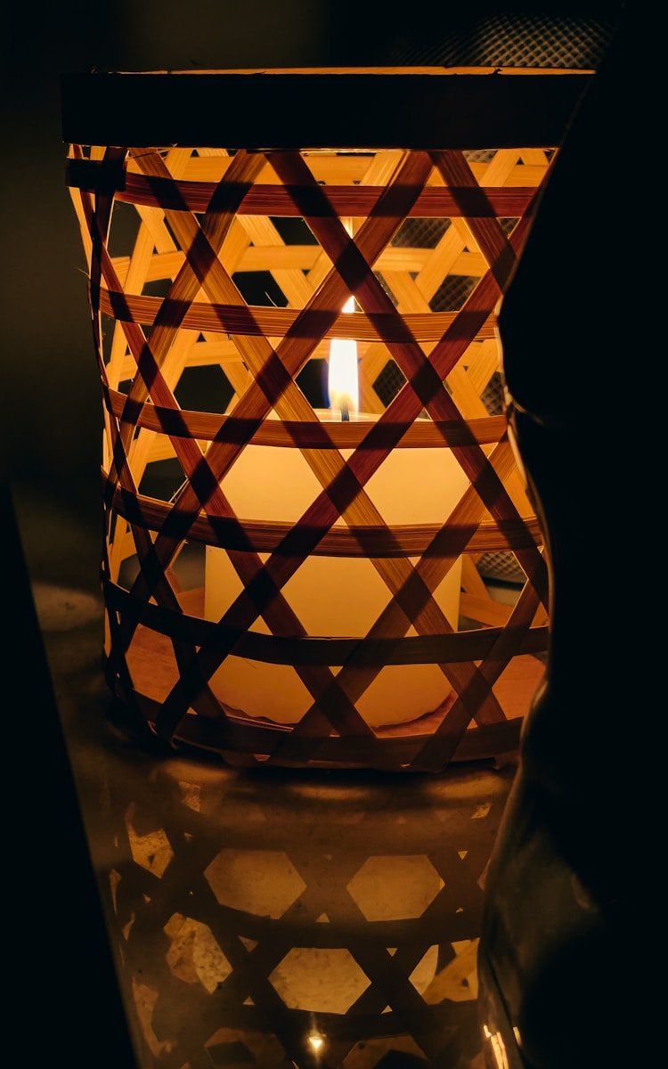a lit candle sitting on top of a table