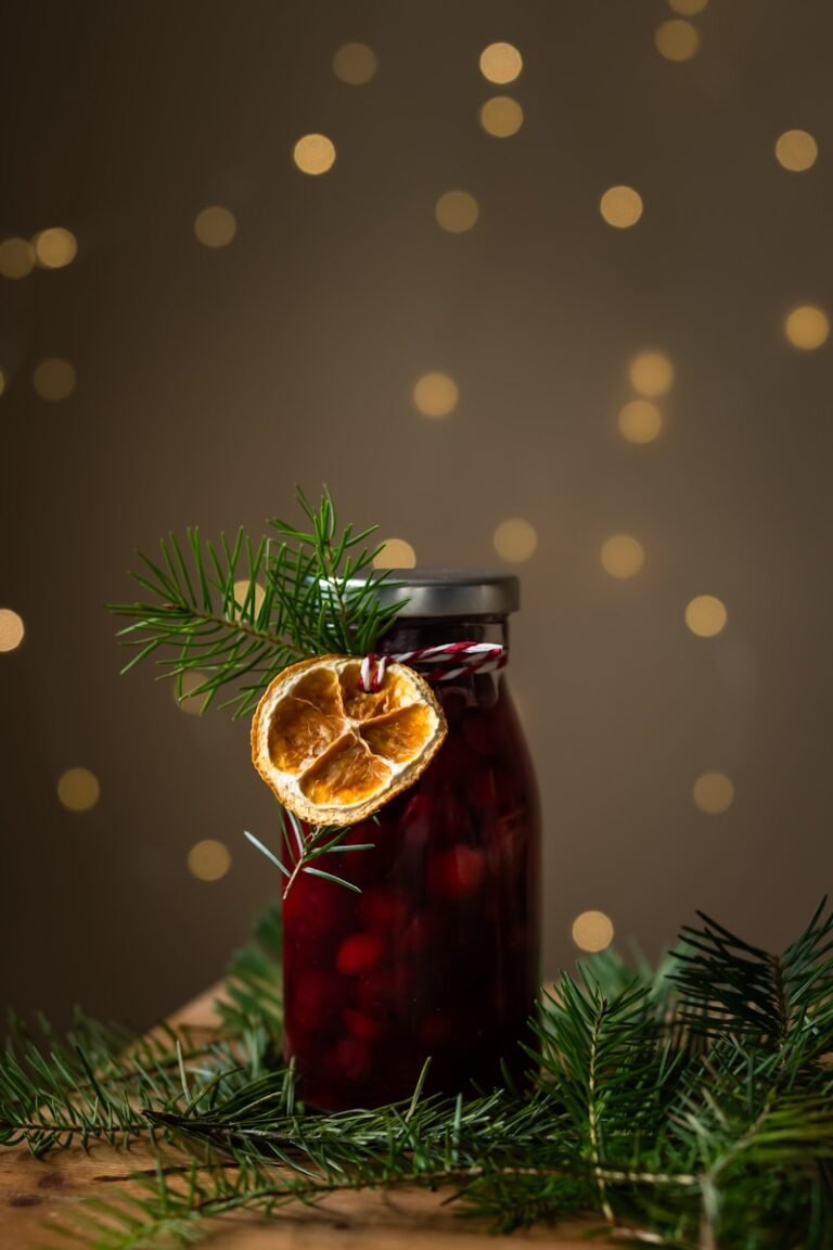 A jar of jam with an orange cut in half