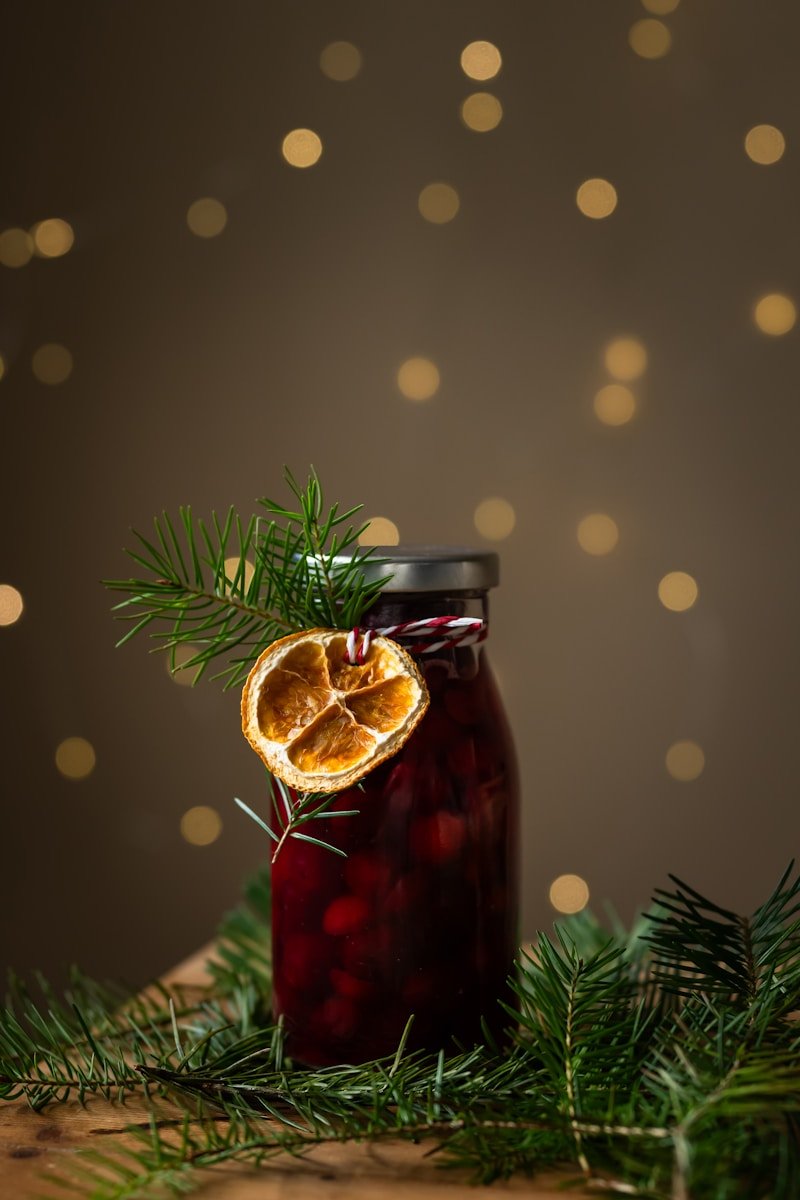 A jar of jam with an orange cut in half