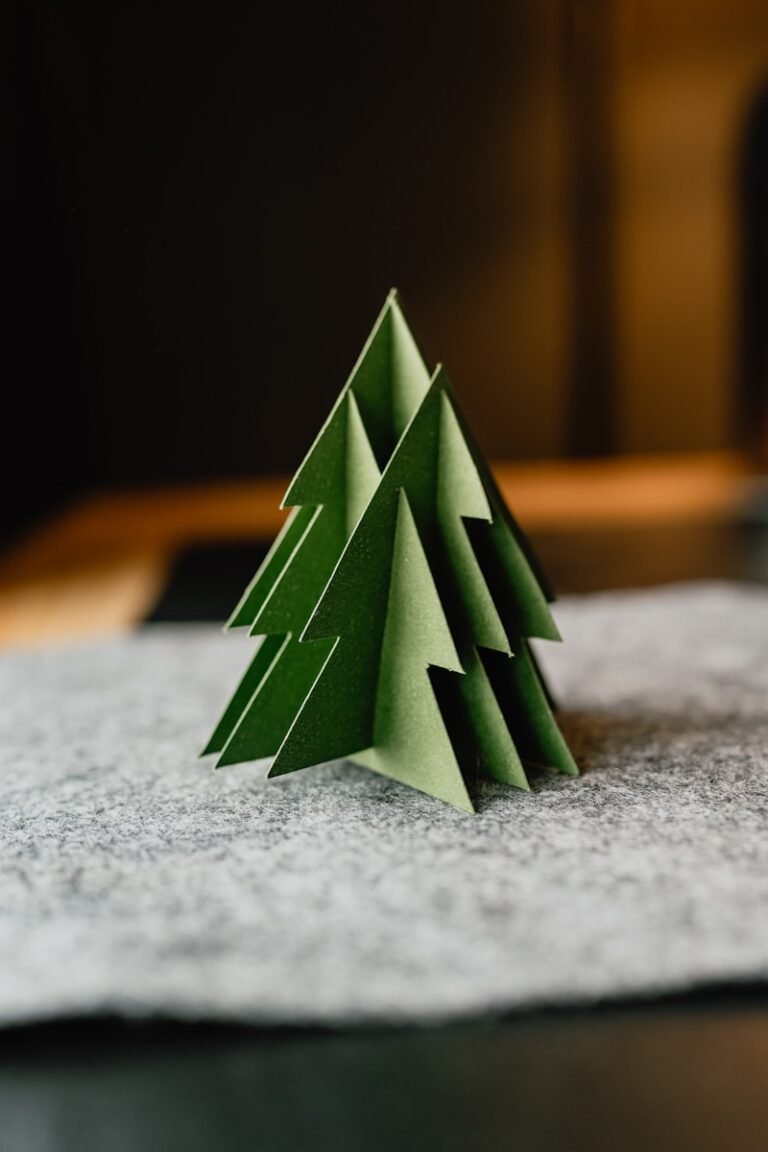 A paper christmas tree sitting on top of a table