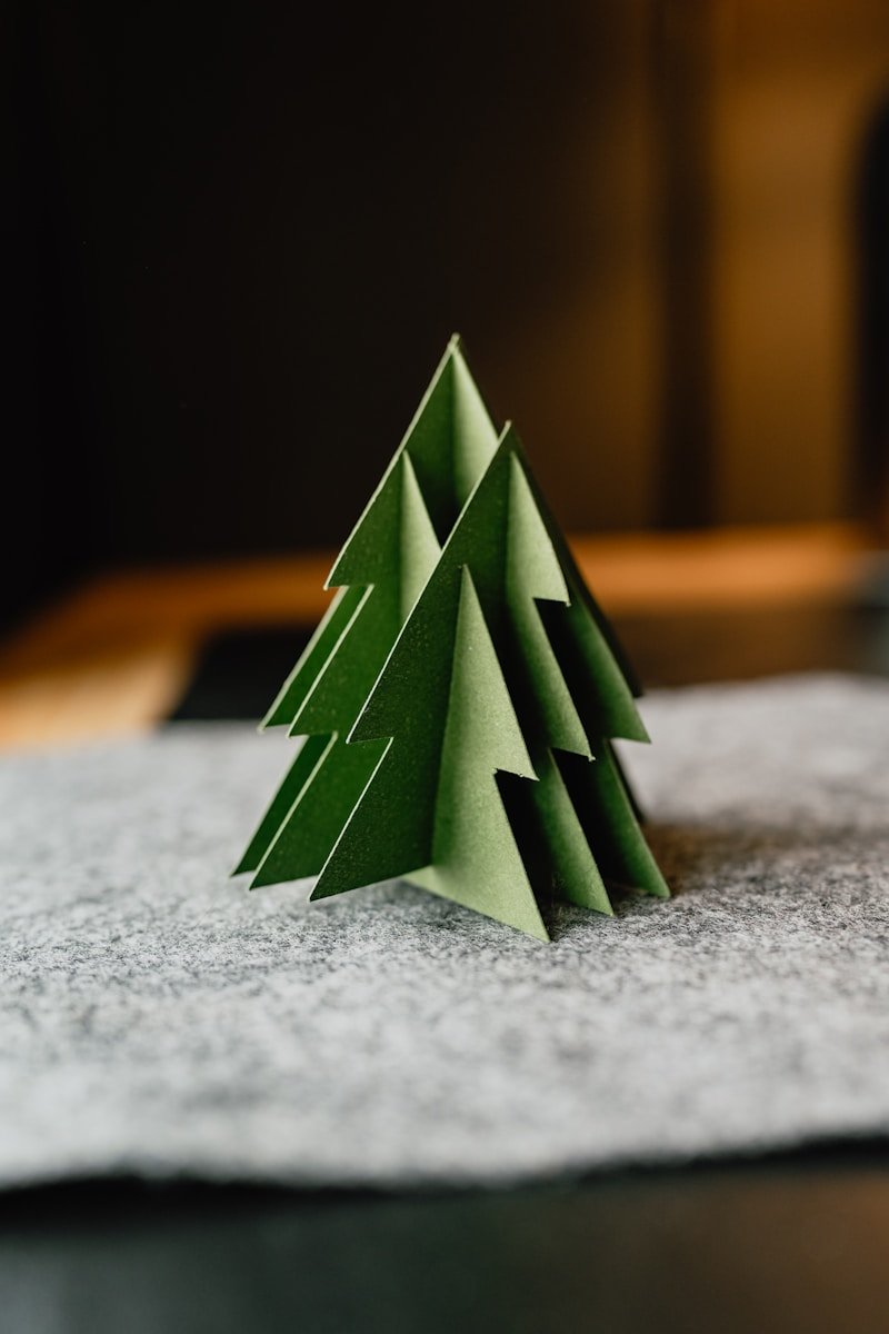 A paper christmas tree sitting on top of a table