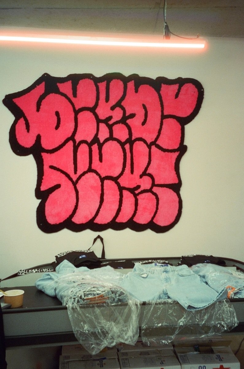 A room with a bed and a painting on the wall