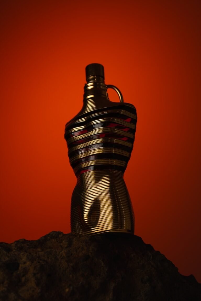 Gold bottle with striped design on rock