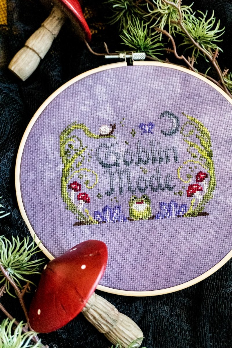 Cross-stitch with "goblin mode" text and forest elements.