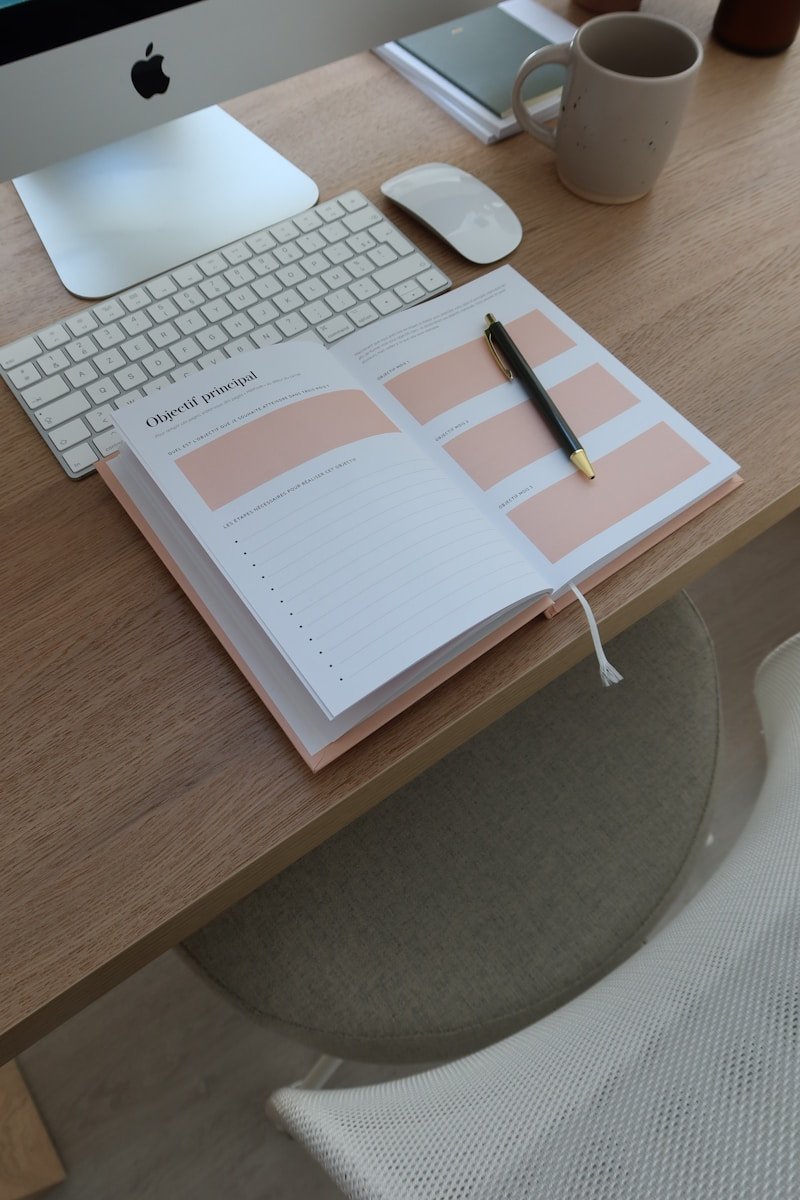 an open notebook sitting on top of a wooden desk