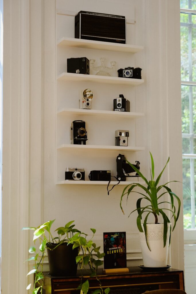 a white shelving unit with objects on it