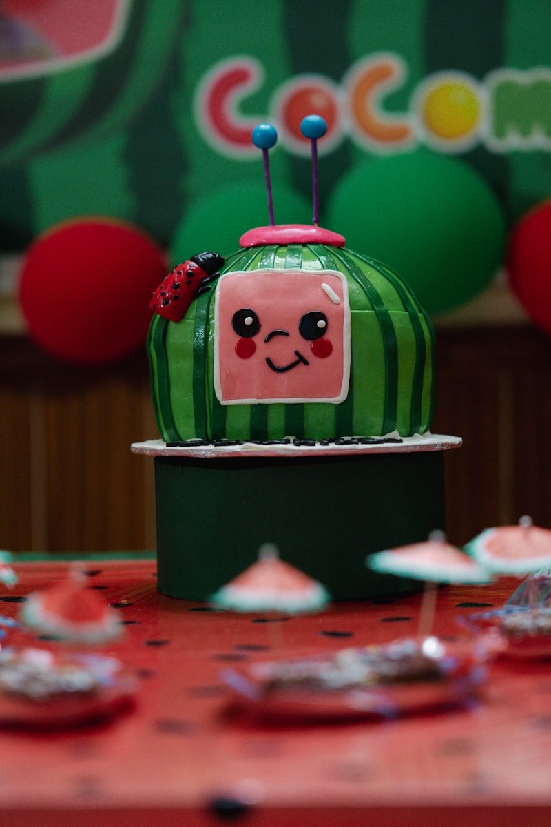 A colorful cocomelon cake is on display.