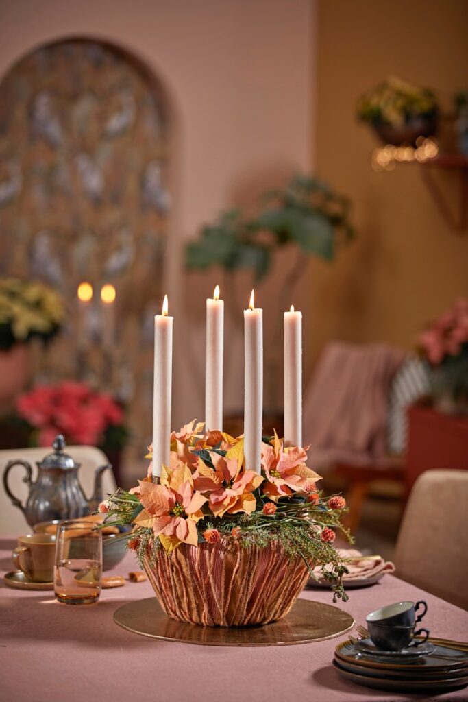 Advent wreath with four candles and poinsettias