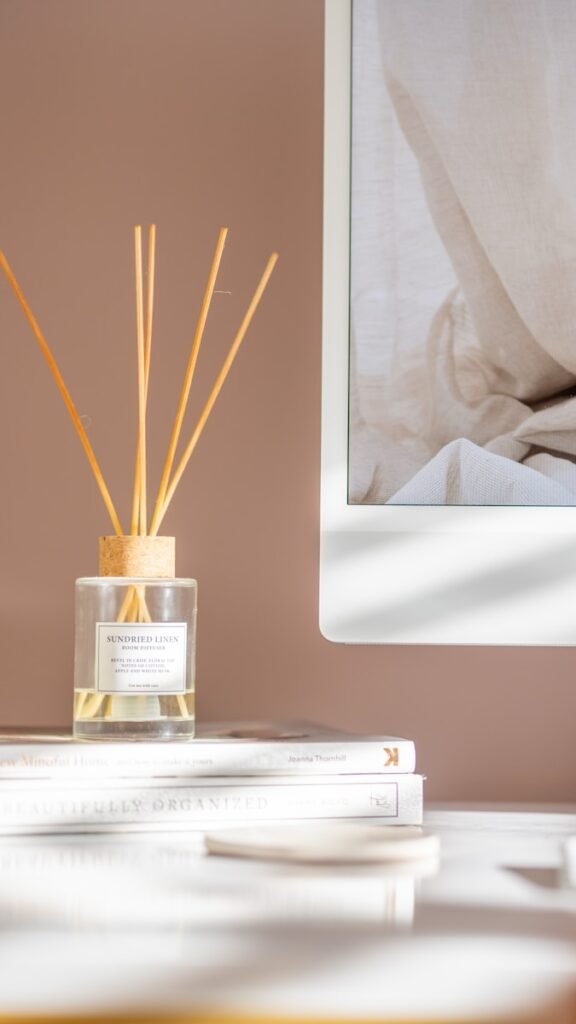 reed sticks in a glass container on top of a book