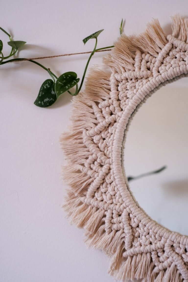 a mirror with a tassel hanging from it