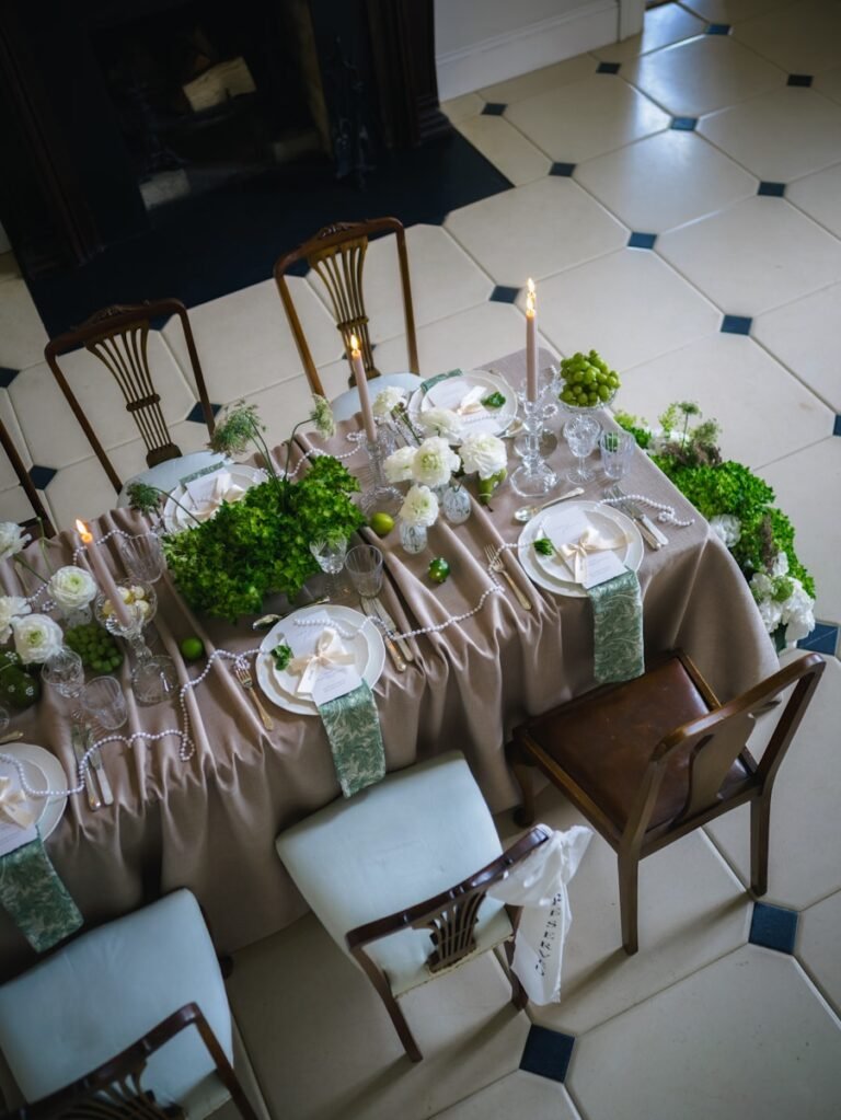 Elegant table setting with floral arrangements and candles.