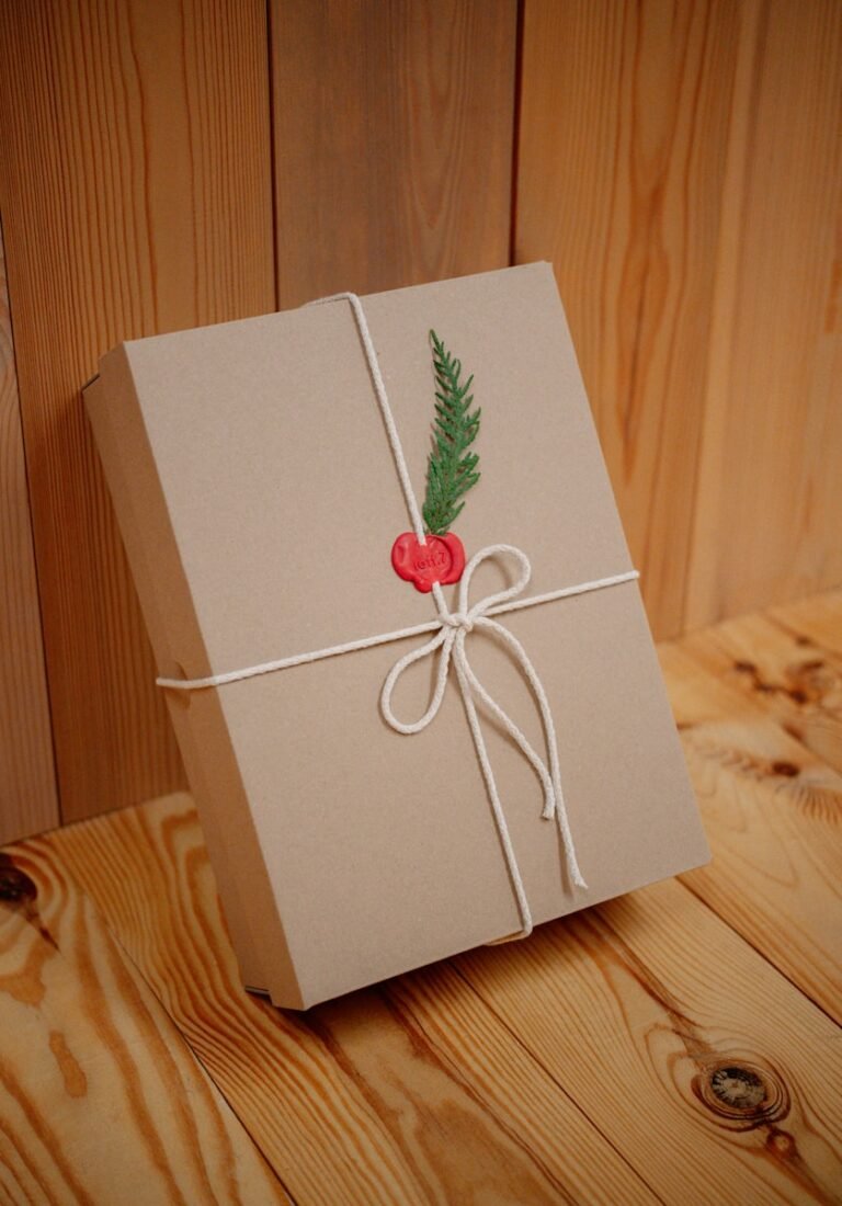 Gift box wrapped with twine and festive greenery