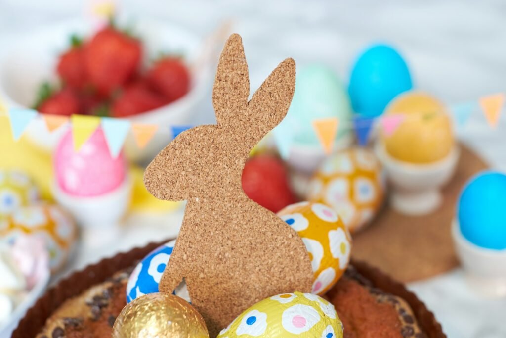 a table topped with a cake covered in chocolate eggs