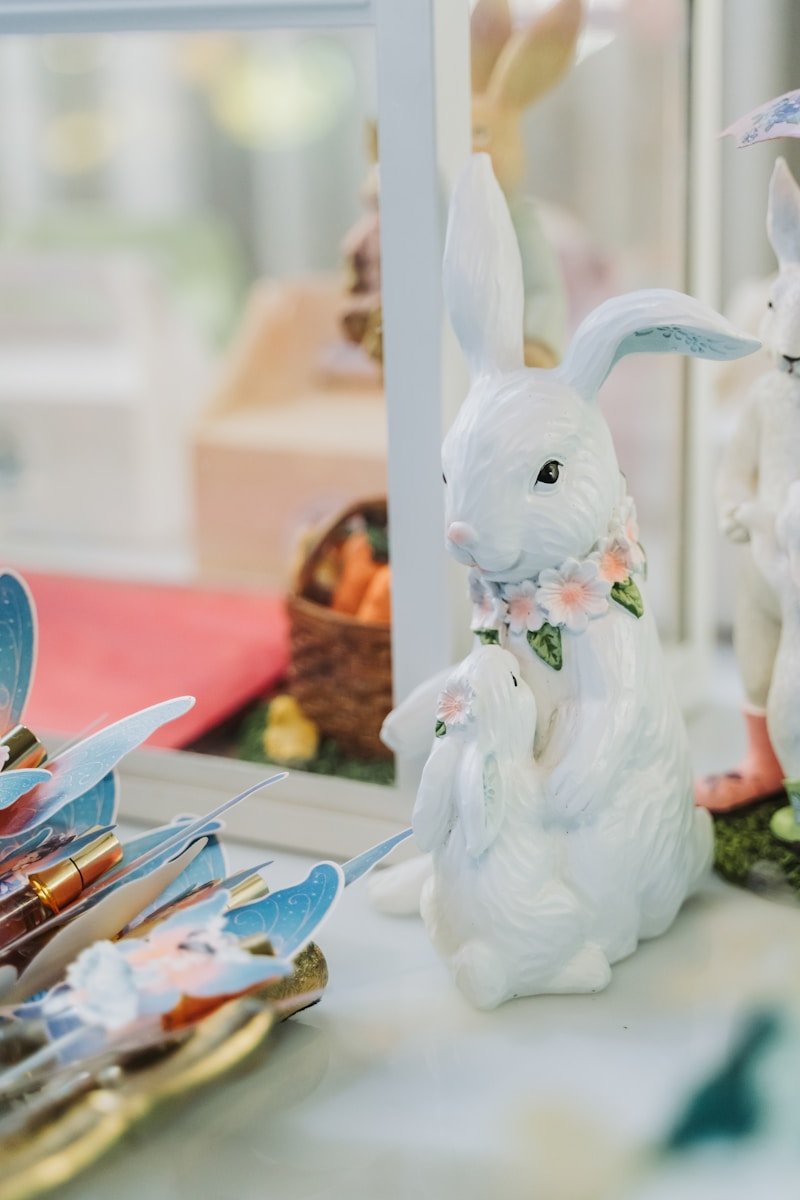 White bunny figurines with floral collars on display.