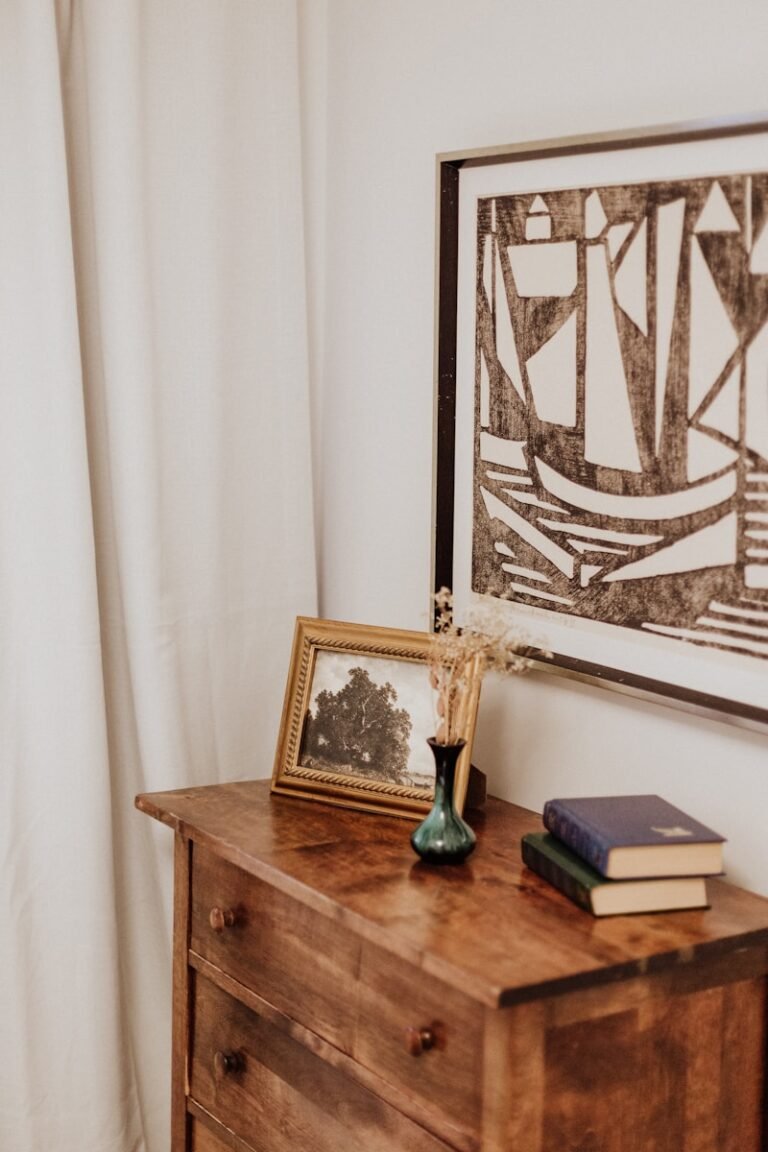 A wooden dresser with a picture on top of it