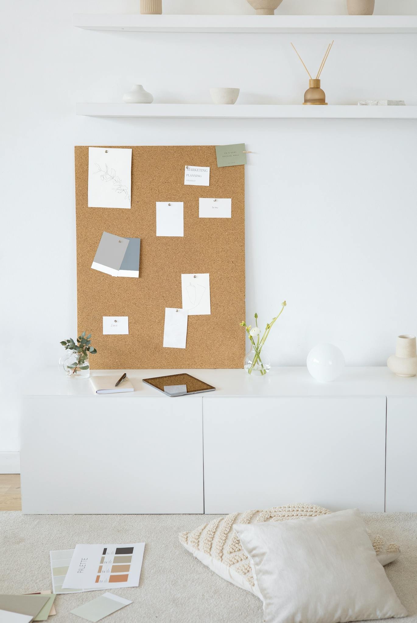 Bright and modern minimalist workspace with cork board for inspiration and creativity.