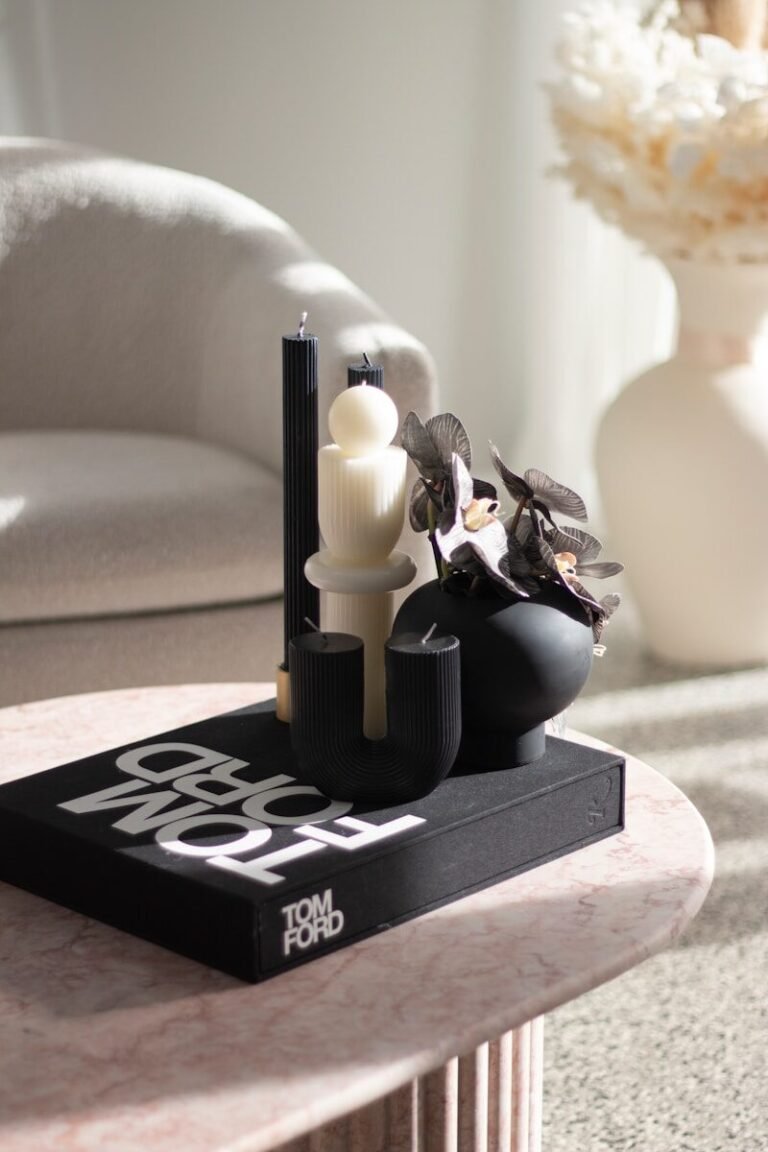 a black and white object with a candle on a black surface